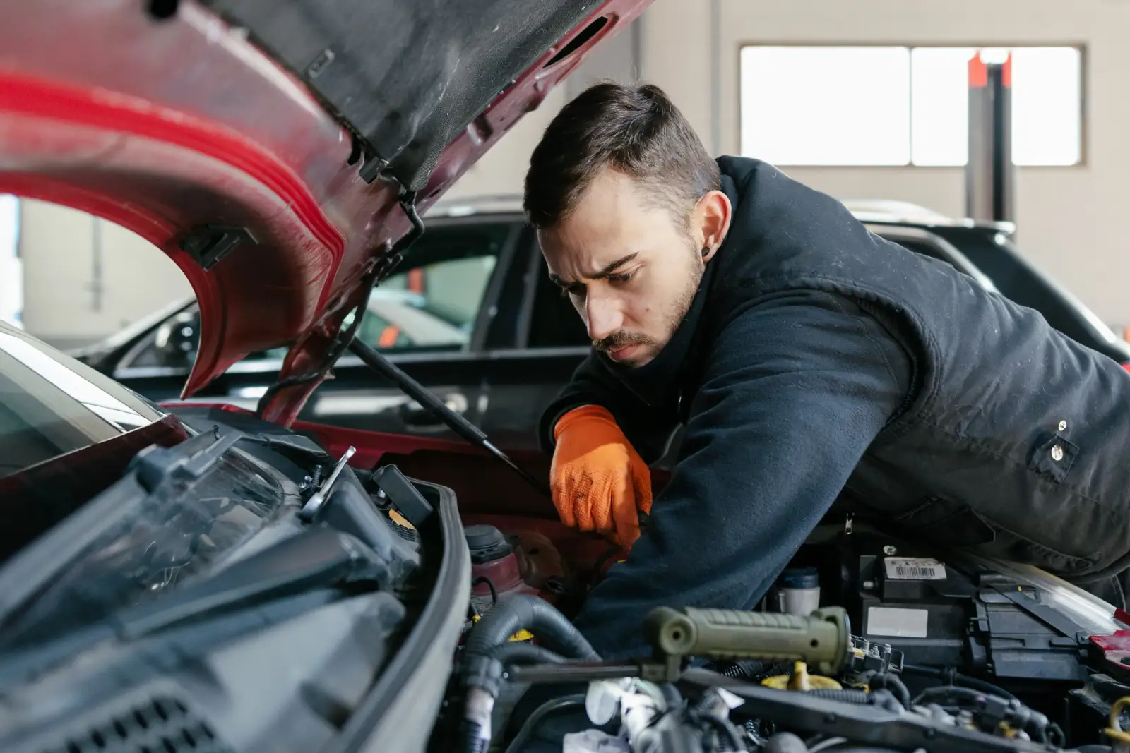 How long does a car service take - professional mechanic servicing car in UK garage